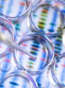 Scientist pipetting a sample for genetic testing with a background of a DNA sequence